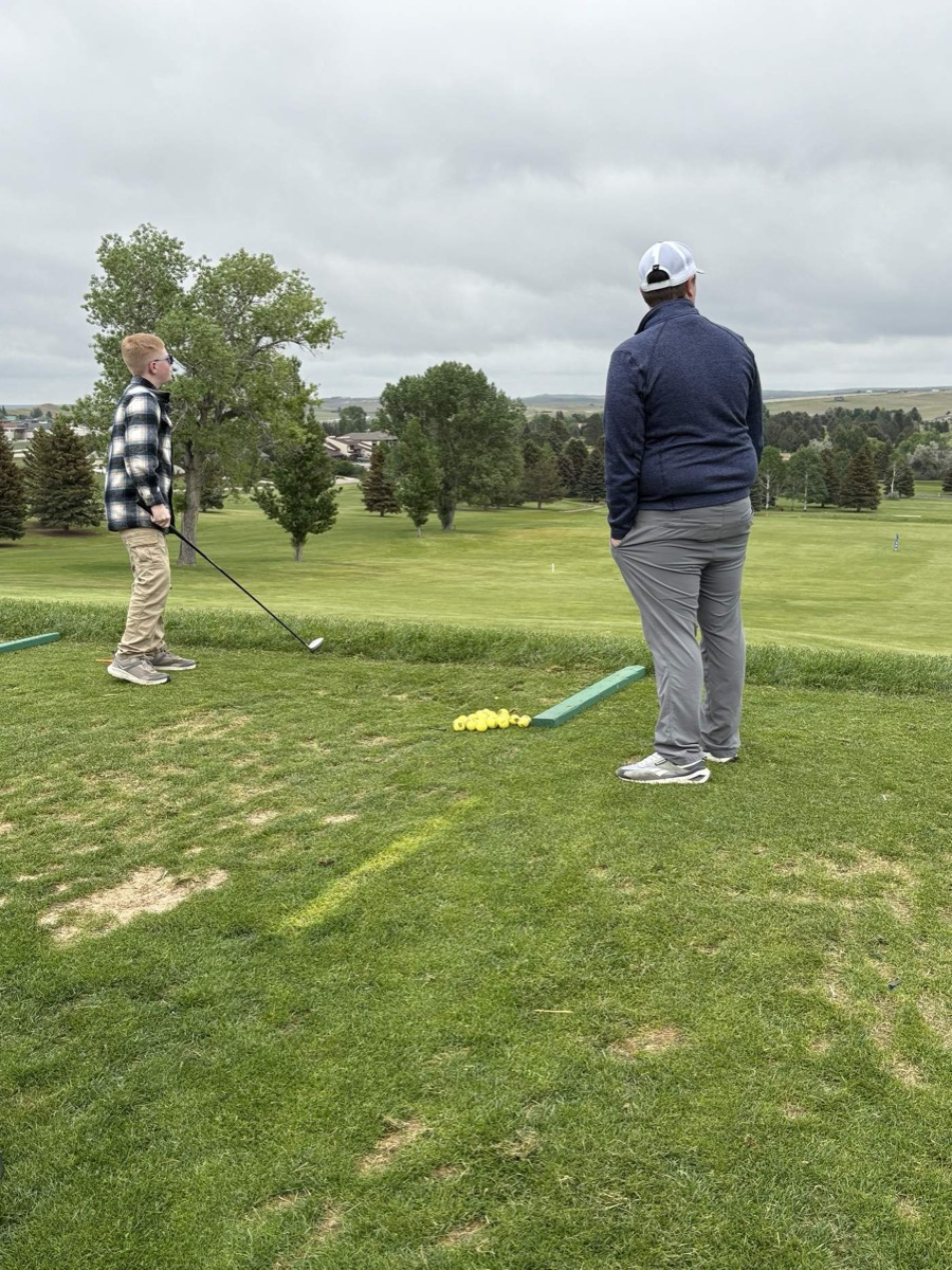 Coach and junior golfer on the range in Wyoming