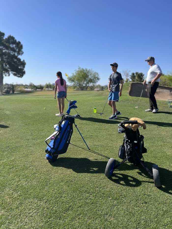 Junior golfers getting set up with their clubs